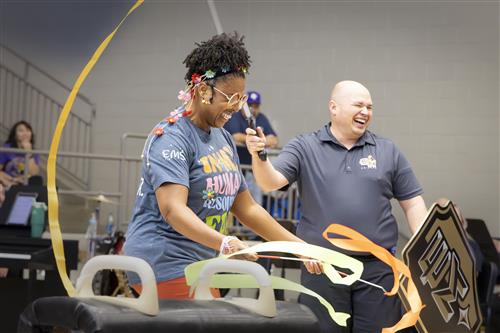 a woman and a man doing ribbon gymnastics
